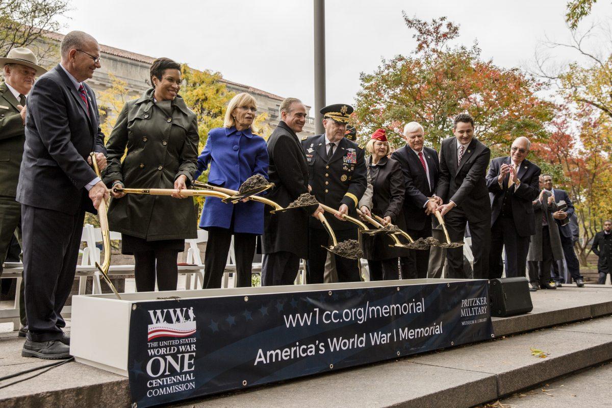 (L–R) Daniel Dayton, president, U.S. Foundation for the Commemoration of the World Wars; Muriel Bowser, mayor of Washington; Sandra Sinclair Pershing, the granddaughter-in-<wbr/>law of General John J. Pershing; David Shulkin, secretary of Veteran Affairs; General Mark A. Milley, 39th chief of staff of the U.S. Army; Keith Harman, commander-in-chief, Veterans of Foreign Wars; Denise H. Rohan, national commander, American Legion; Terry Hamby, chairman, U.S. World War I Centennial Commission; and Kenneth Clarke, president and CEO, Pritzker Military Museum and Library perform the ceremonial groundbreaking for the National World War I Memorial at Pershing Park in Washington on Nov. 9, 2017. (Samira Bouaou/The Epoch Times)