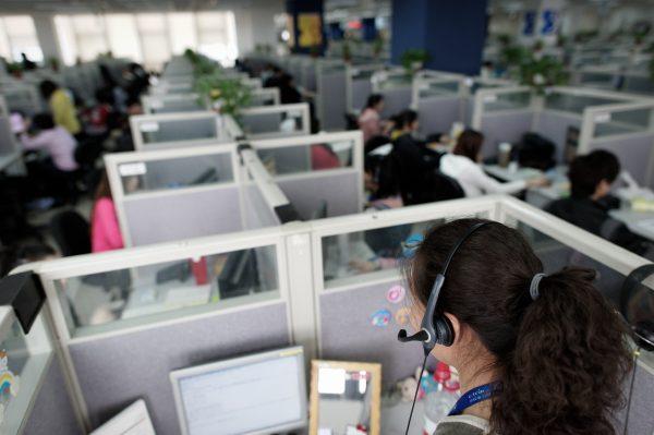 Employees at an office in Shanghai, on March 9, 2011. (Andrew Ross/AFP/Getty Images)