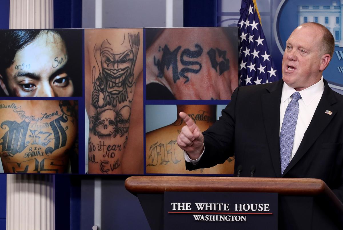 Acting ICE Director Tom Homan in front of MS-13 gang-related photos during a press briefing at the White House on July 27, 2017. (Win McNamee/Getty Images)