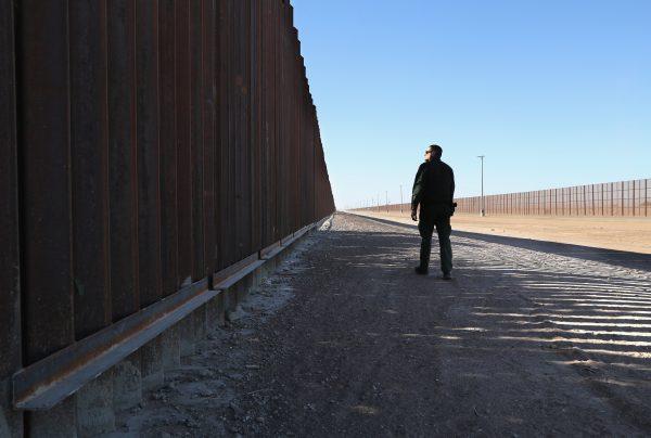 A Border Patrol agent stands at the U.S.-Mexico border fence in San Luis, Ariz., on Nov. 17, 2016. The U.S. government built triple fencing to deter illegal immigrants and smugglers who previously easily crossed the border there. (John Moore/Getty Images)