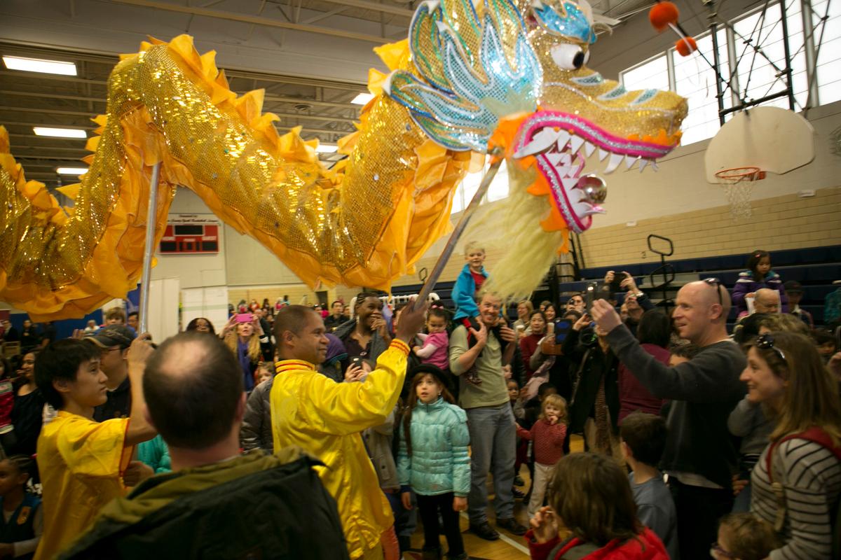 The dragon leads a parade through Luther Jackson Middle School at the 10th Annual Chinese New Year Festival in Falls Church, Virginia, on Jan. 14, 2017. (Asian Community Service Center)