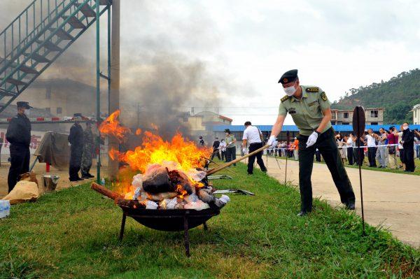Chinese army soldiers burn piles of drugs during a destruction ceremony ahead of the United Nations "International Day against Drug Abuse and Illicit Trafficking" in Baoshan City in Yunnan, on June 25, 2017. (STR/AFP/Getty Images)