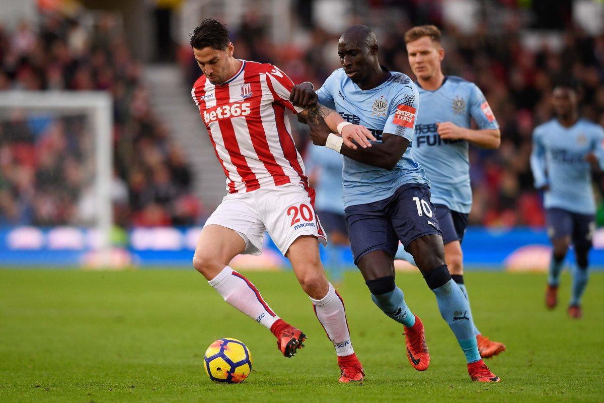 Geoff Cameron of Stoke City and Mohamed Diame of Newcastle United battle for possession during the Premier League match between Stoke City and Newcastle United at Bet365 Stadium in Stoke on Trent, England, on Jan. 1, 2018. (Stu Forster/Getty Images)