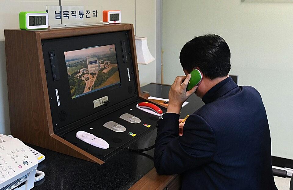 A South Korean government official checks the direct communications hotline to talk with the North Korean side at the border village of Panmunjom on Jan. 3, 2018 in Panmunjom, South Korea. (South Korean Unification Ministry via Getty Images)