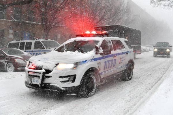 A NYPD vehicle drives through Harlem during the snow storm in New York City on Jan. 4, 2018. (Dia Dipasupil/Getty Images)