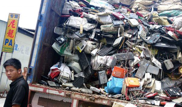 Workers unload a truck with electronic waste in Guiyu Township, Shantou City, in Guangdong Province on Aug. 9, 2014. (Johannes Eisele/AFP/Getty Images)