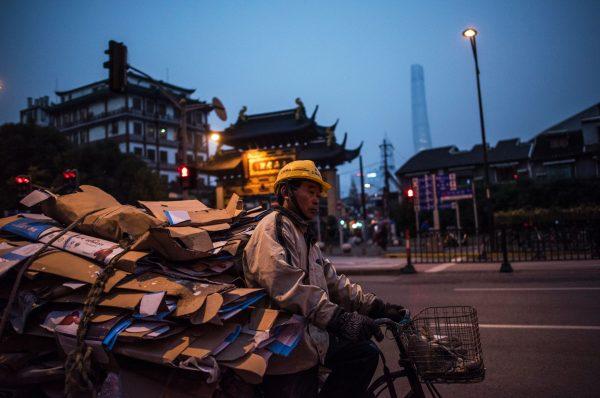 A scrap collector on his tricycle pedals along a road in Shanghai on December 16, 2016. (Johannes Eisele/AFP/Getty Images)