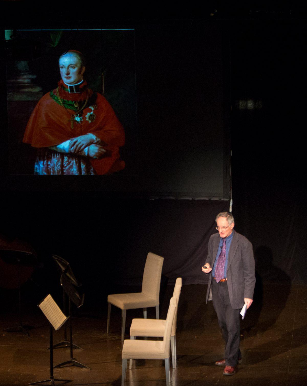 Misha Donat shows a photograph of Archduke Rudolf of Austria, as he gives his talk about Schubert at the Bohemian National Hall in New York on Dec. 14, 2017. (Benjamin Chasteen/The Epoch Times)