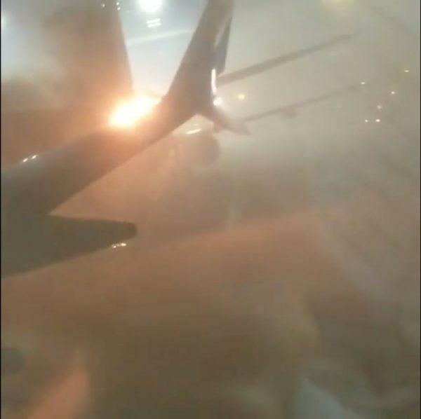 An explosion is seen through a window of a plane that has collided with another plane at Toronto's Pearson Airport, Canada, Jan. 5, 2018 in this still image taken from social media video. (@STEPHEN_BELFORD/via Reuters)