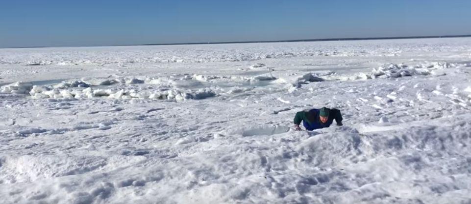Don't do this: People walk on ice that formed over the bay in Falmouth, Massachusetts, which froze over due to plunging temperatures. (YouTube video - Ryan Canty / screenshot)