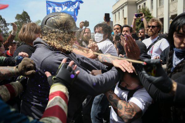 Trump supporters are pepper sprayed during a clash with protesters at a "Patriots Day" free speech rally in Berkeley, Calif., on April 15, 2017. (Elijah Nouvelage/Getty Images)