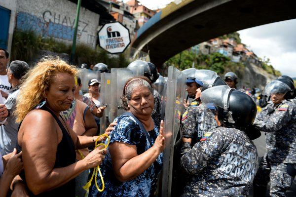 People confront riot police during a protest against the shortage of food in Caracas, Venezuela, on Dec. 28, 2017. (Federico Parra/AFP/Getty Images)