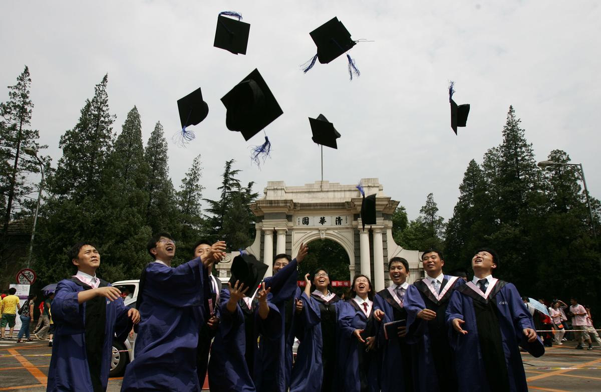 Students throw their graduation caps into the air during a ceremony held at Tsinghua University on July 18, 2007. (China Photos/Getty Images)
