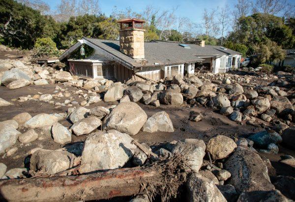 Boulders surround a mud-filled property after a mudslide in Montecito, California, U.S. January 12, 2018. (Reuters/Kyle Grillot)