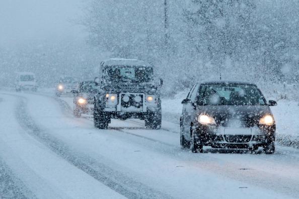 Motorists drive through snowy conditions in Pickering, northern England, on January 15, 2013. (Lindsey Parnaby/AFP/Getty Images)