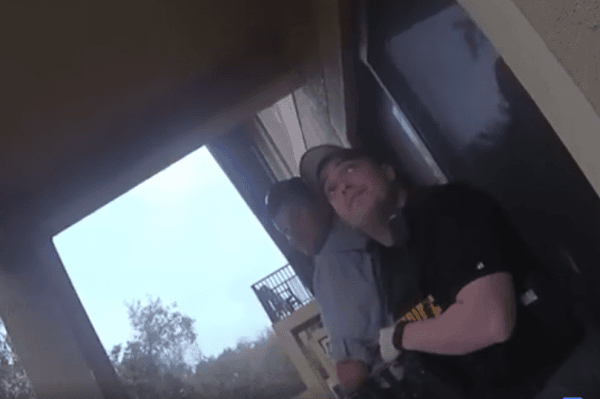 A screenshot of the bodycam shows officers waiting below the apartment (Pasco County Sheriff)