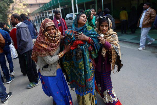 Relatives of a victim, who was who was killed in Saturday’s fire in a warehouse, mourn as they wait outside a hospital in New Delhi, India, January 21, 2018. (Reuters/Adnan Abidi)