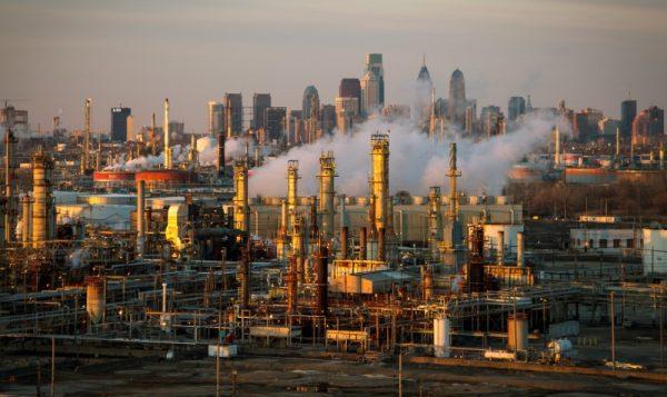 The Philadelphia Energy Solutions oil refinery owned by The Carlyle Group is seen at sunset in front of the Philadelphia skyline on March 24, 2014. (David M. Parrott/File Photo/Reuters)