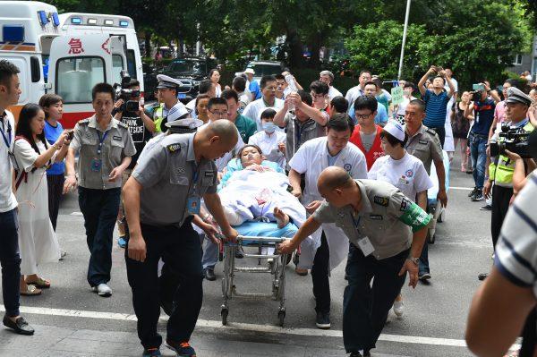 An injured woman arrives at a hospital in China's southwestern Sichuan Province on August 9, 2017. (STR/AFP/Getty Images)