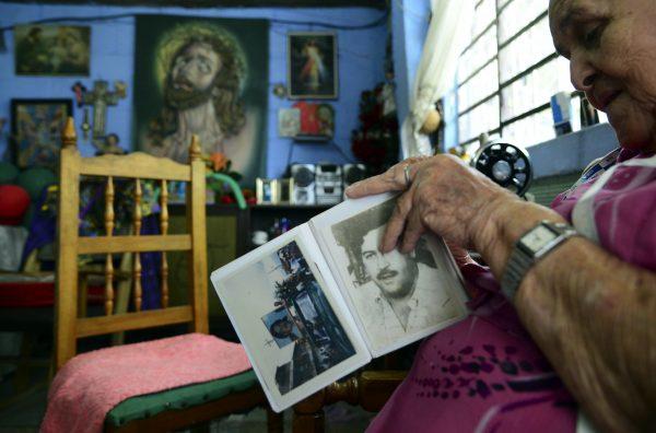 Irene Gaviria shows an album with pictures of late Colombian drug lord Pablo Escobar at her home in the Pablo Escobar neighborhood in Medellín, Colombia, on Dec. 2, 2015. Some 22 years after his death, Escobar is still revered by many people. (Raul Arboleda/AFP/Getty Images)