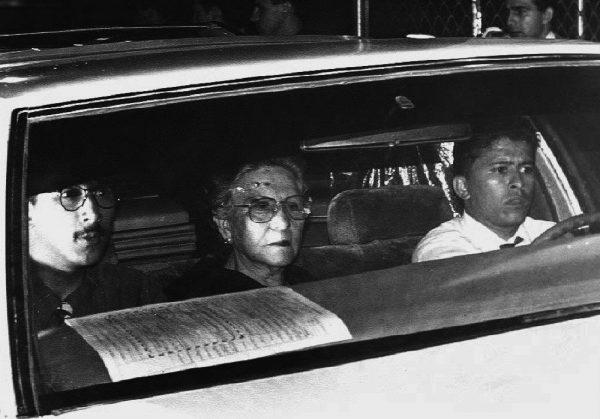 The mother of Pablo Escobar, Hermilda Gaviria (C), rides in a car taking Escobar's casket to a funeral home, Dec. 2, 1993, from the local coroners office in Medellin, Colombia. She is accompanied by an unidentified relative (L) and an unidentified man. Escobar was killed in Medellin by members of a police and army elite group formed to hunt for the head of the Medellin drug cartel. (B/AFP/Getty Images)