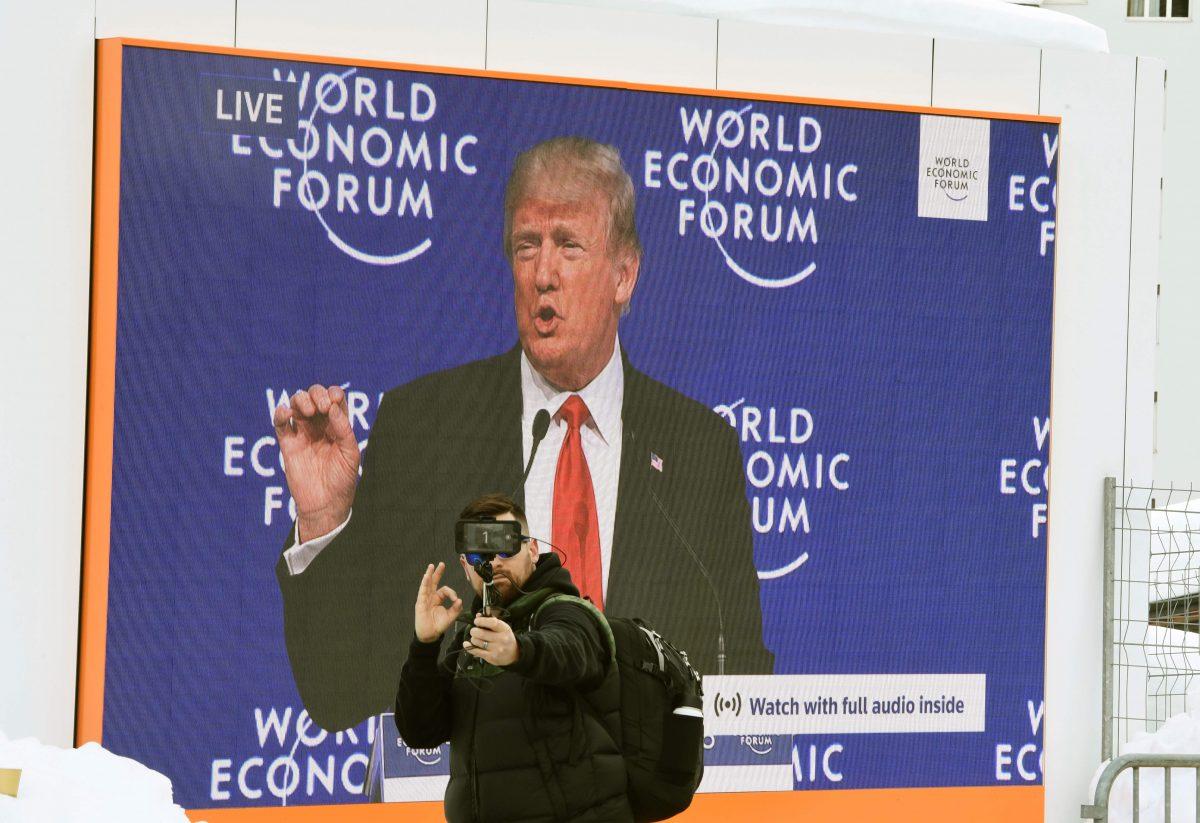 A man takes a selfie during President Trump’s speech at the WEF in Davos, on Jan. 26, 2018. (MIGUEL MEDINA/AFP/Getty Images)