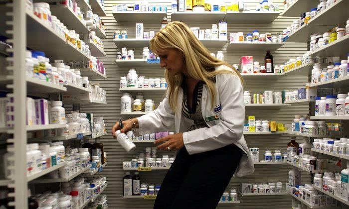 A pharmacy manager retrieves a prescription drug from the shelf in Miami, Florida, in this file photo. (Joe Raedle/Getty Images)