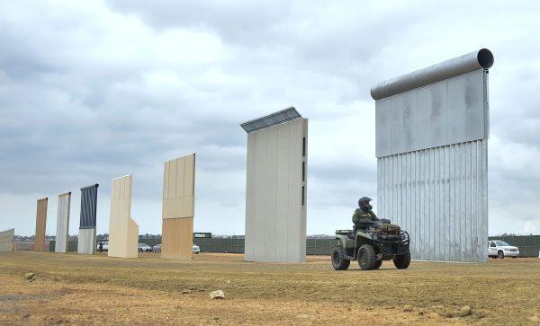 A Homeland Security border patrol officer rides an ATV past prototypes of President Donald Trump's proposed border wall in San Diego, Calif., on Nov. 1, 2017. (FREDERIC J. BROWN/AFP/Getty Images)