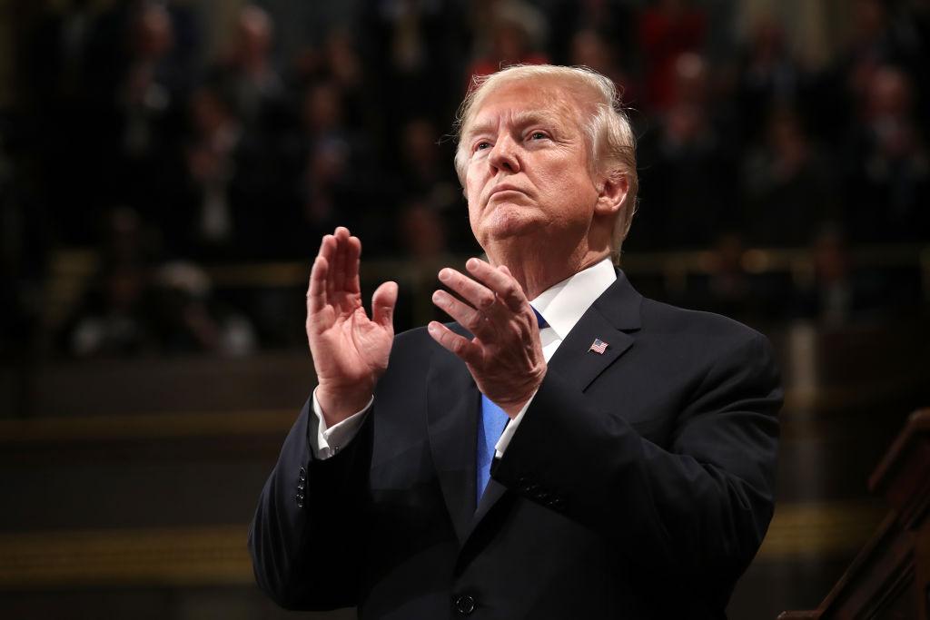 President Donald Trump claps during the State of the Union address in the chamber of the US House of Representatives on Jan. 30, 2018. (WIN MCNAMEE/AFP/Getty Images)
