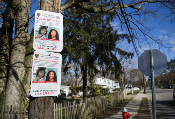 A sign offering a reward for information regarding the murders of Nisa Mickens and Kayla Cuevas, near Brentwood High School where they studied, in Brentwood, N.Y., on March 29, 2017. (Samira Bouaou/The Epoch Times)