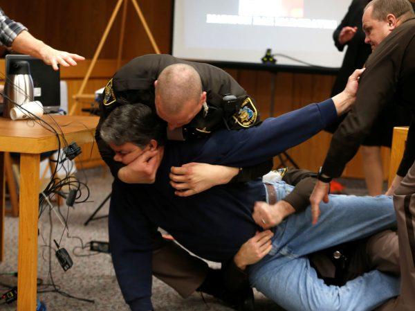 Eaton County Sheriffs restrain Randall Margraves after he lunged at Larry Nassar in the Eaton County Circuit Court, Michigan, U.S.. (Reuters/Rebecca Cook)