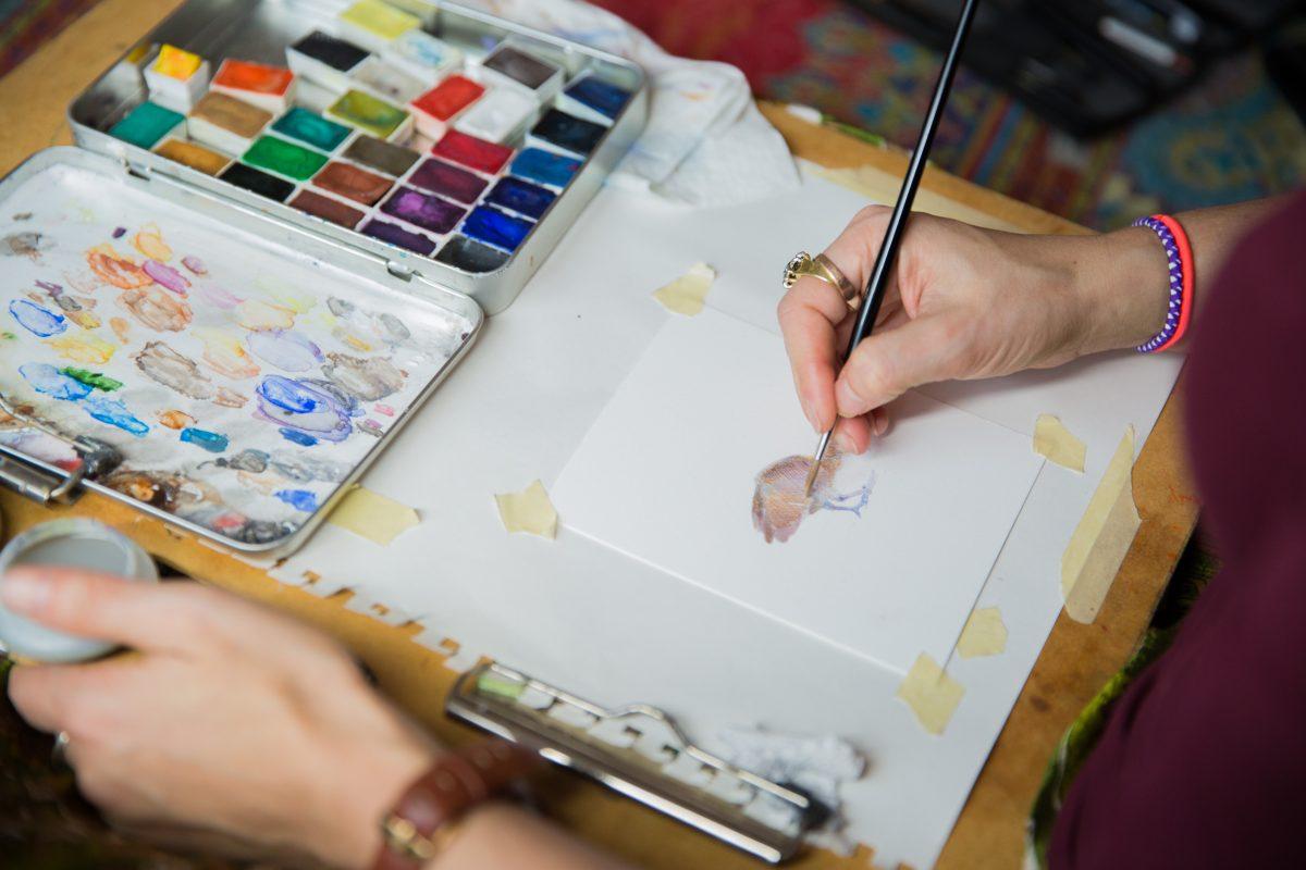 Dina Brodsky paints a bird, at her home on Jan. 22, 2018. (Benjamin Chasteen/The Epoch Times)