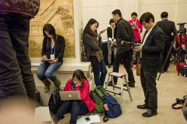 Chinese journalists at work during the third session of the 12th National People's Congress outside the Great Hall of the People in Beijing on March 9, 2015. (Fred Dufour R/AFP/Getty Images)