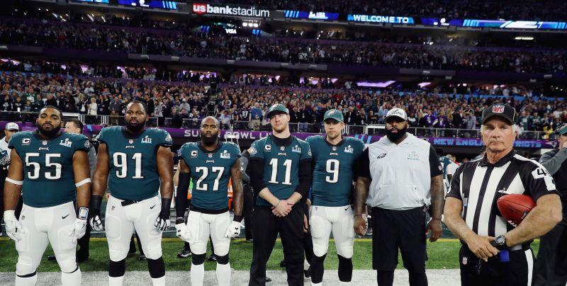 Brandon Graham #55, Fletcher Cox #91, Malcolm Jenkins #27, Carson Wentz #11 and Nick Foles #9 of the Philadelphia Eagles stand for the national anthem prior to Super Bowl LII against the New England Patriots at U.S. Bank Stadium in Minneapolis, Minnesota on February 4, 2018. (Photo by Elsa/Getty Images)