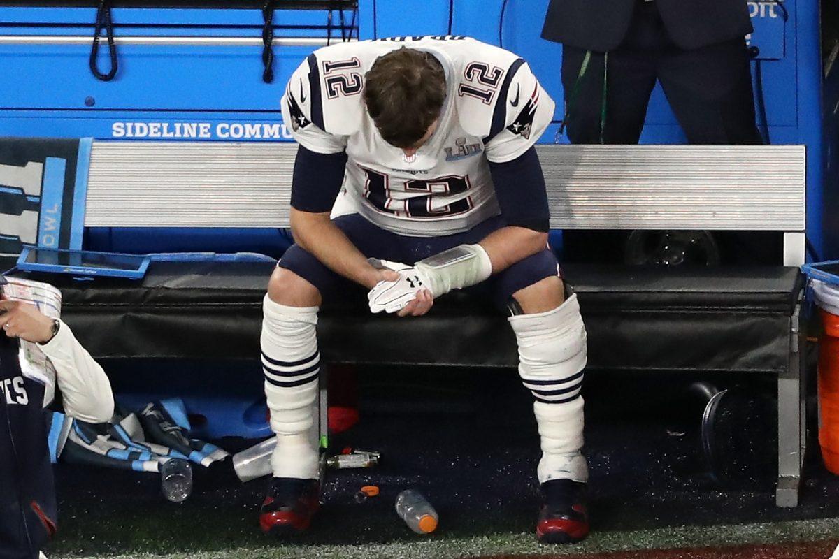 Tom Brady #12 of the New England Patriots sits on the bench after having the ball stripped by Brandon Graham #55 of the Philadelphia Eagles late in the fourth quarter in Super Bowl LII at U.S. Bank Stadium in Minneapolis, Minn., on Feb. 4, 2018. (Christian Petersen/Getty Images)