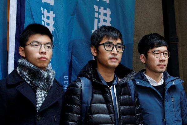 Pro-democracy activists (L-R) Joshua Wong, Alex Chow and Nathan Law pose outside the Court of Final Appeal before a verdict on their appeal in Hong Kong, China Feb. 6, 2018. (Reuters/Bobby Yip)