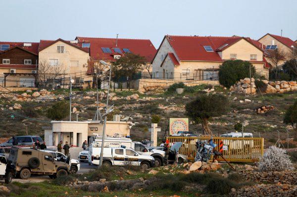 Israeli troops gather at the scene of a stabbing attack north of Hebron, in the occupied West Bank, Feb. 7, 2018. (Reuters/Mussa Qawasma)