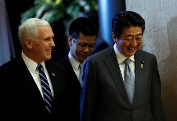 U.S. Vice President Mike Pence and Japan's Prime Minister Shinzo Abe walk before they review an honor guard before their meeting at Abe's official residence in Tokyo, Japan, Feb. 7, 2018. (Reuters/Toru Hanai)
