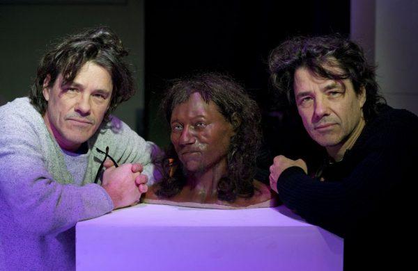 Model makers Adrie (L) and Alfons Kennis pose with their full face reconstruction model, made from the skull of a 10,000 year old man, known as Cheddar Man, Britain's oldest complete skeleton, during a press preview at the National History Museum in London on Feb. 6, 2018. (Justin Tallis/AFP/Getty Images)