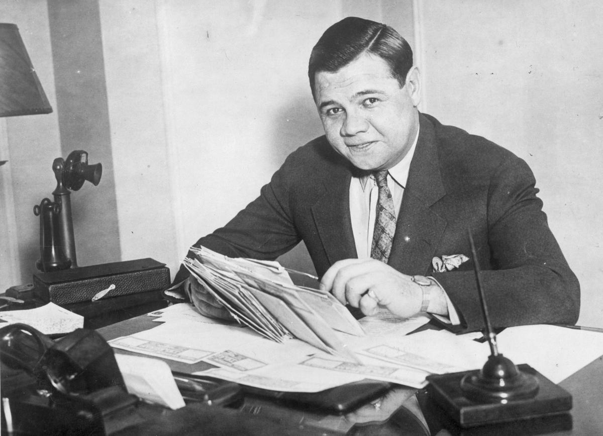 circa 1935: Babe Ruth (George Herman Ruth, 1895 - 1948) American professional baseball player signs a new two year contract with the 'New York Yankees'. (General Photographic Agency/Getty Images)
