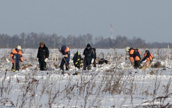 Russian Emergency Situations Ministry members work at the crash site of the short-haul AN-148 airplane operated by Saratov Airlines in Moscow Region, Russia February 12, 2018. (Reuters/Tatyana Makeyeva)