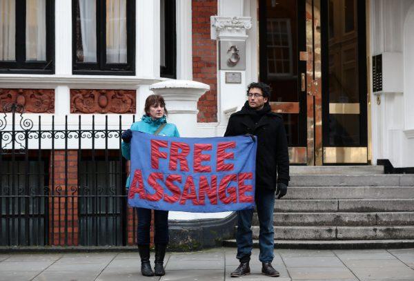 Assange supporters hold a banner outside the Ecuadorian Embassy in London, Britain, Feb. 13, 2018. (Reuters/Peter Nicholls)