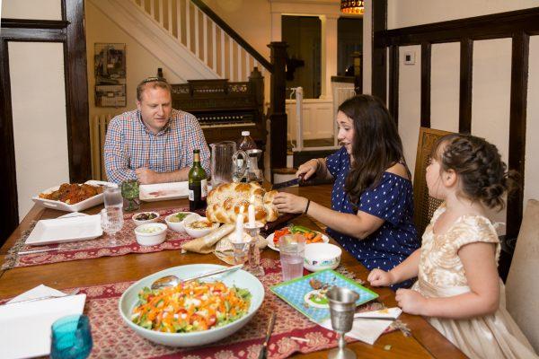 Everyone sits down for Shabbat dinner. (Samira Bouaou/The Epoch Times)