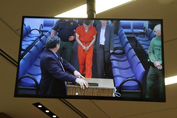 Nikolas Cruz, 19, a former student at Marjory Stoneman Douglas High School in Parkland, Florida, where he allegedly killed 17 people, is seen on a closed circuit television screen during a bond hearing in front of Broward Judge Kim Mollica at the Broward County Courthouse on February 15, 2018 in Fort Lauderdale, Florida. (Photo by Susan Stocker - Pool/Getty Images)