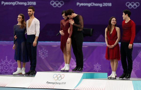 Gold medallists Tessa Virtue and Scott Moir of Canada, silver medallists Guillaume Cizeron and Gabriella Papadakis of France, and bronze medallists Maia Shibutani and Alex Shibutani of the U.S. celebrate on the podium during the victory ceremony of ice dance free dance competition during the Pyeongchang 2018 Winter Olympics. (Reuters/John Sibley)