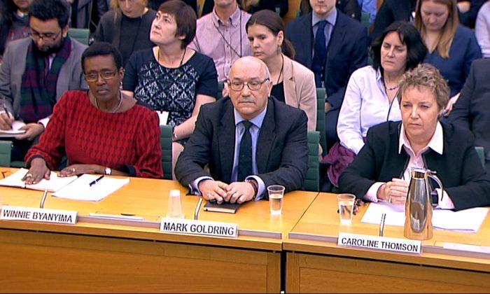 Oxfam's chief executive Mark Goldring, Oxfam international's director Winnie Byanyima and Oxfam's chair Caroline Thomson attend a hearing of Parliament's International Development Committe in London, Britain, February 20, 2018. (Reuters/Parliament TV handout)