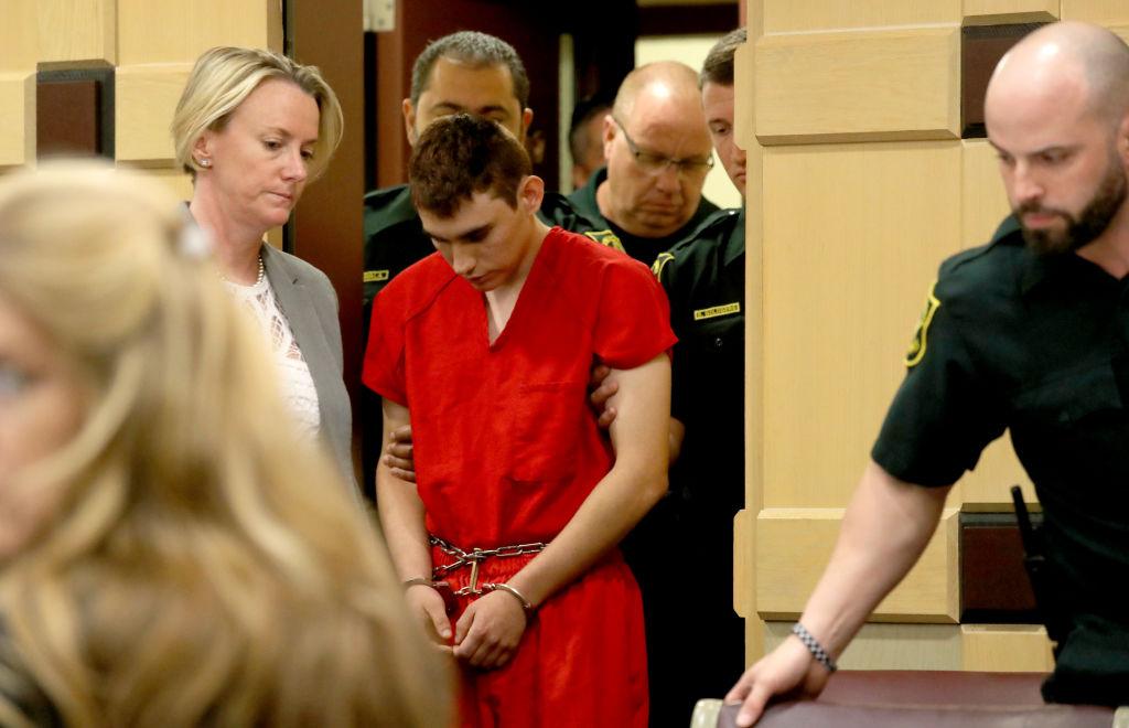 Nikolas Cruz appears in court with attorney Melissa McNeil (L) for a status hearing before Broward Circuit Judge Elizabeth Scherer in Ft. Lauderdale, Florida on Feb. 19, 2018. (Mike Stocker-Pool/Getty Images)