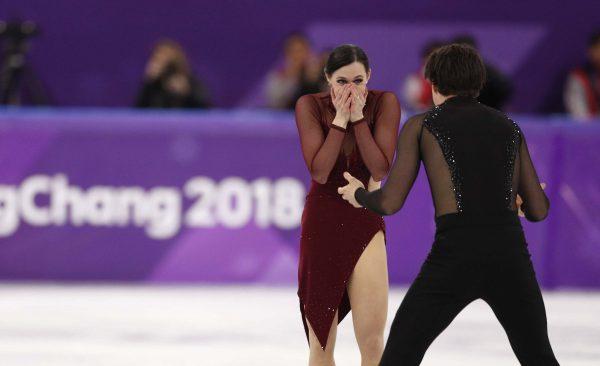 Canadians Tessa Virtue and Scott Moir react after their performance at the ice dance free dance competitions during the Pyeongchang 2018 Winter Olympics on Feb. 20, 2018. (Reuters/John Sibley)
