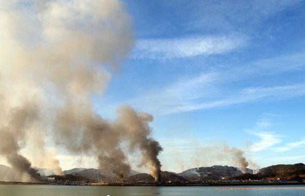 Plumes of smoke rise from Yeonpyeong island in the Yellow Sea on Nov. 23, 2010, after a North Korean shelling attack. (STR/AFP/Getty Images)