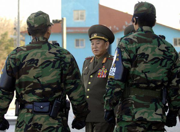 Kim Yong Chol (C) walks by South Korean soldiers after the inter-Korean general talks at the south side of the truce village of Panmunjom, in the Demilitarized Zone on Dec. 14, 2007. (Jung Yeon-Je/AFP/Getty Images)